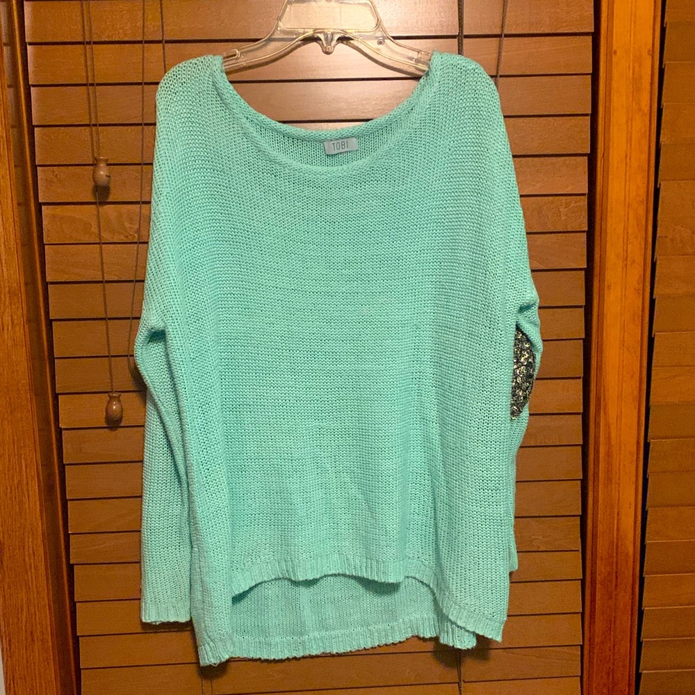 Mint green sweater with gold sequin elbow patches